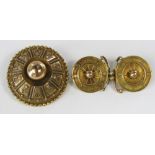 Two yellow metal brooches comprising an Etruscan revival type example of disc form and a memorial