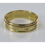 An 18ct diamond set wedding ring, size N, 4g