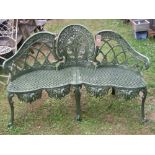 A Victorian style cast aluminium garden bench the seat with serpentine outline and pierced lattice