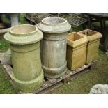 A near pair of reclaimed weathered buff coloured chimney pots of cylindrical form together with