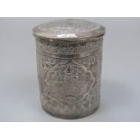 Eastern white metal lidded cylindrical pot typically decorated with Arabic panels embossed with