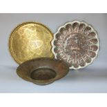 Two large metal chargers together with a further large eastern copper bowl (3)