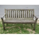 An Alexander Rose Ltd weathered teak three seat garden bench with open slatted seat and curved