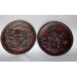 A pair of Japanese bronze chargers decorated in high relief with birds amidst branches, 36cm