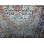 A Persian wool rug, the central plum coloured medallion within pale pastel green field,