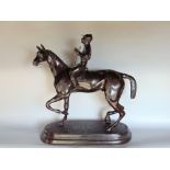Cast bronze study of a jockey on horse back signed C Valton, 63cm high