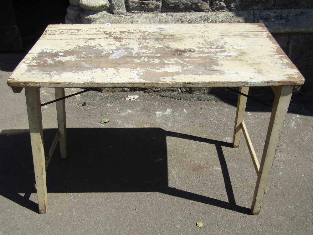 A simple painted pine folding trestle table with square tapered legs, 106 cm x 60 cm approx