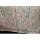 A good quality crewel work type rug, centrally decorated with typical medallions with geometric