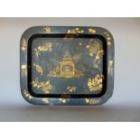 Chinoiserie black and gilt lacquered tray, centrally decorated with a standing attendant by the side