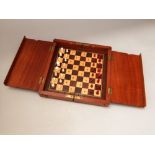 A mahogany cased travel games/chess set, 26cm long