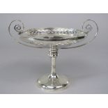 An early 20th century silver twin handled tazza with scrolled handles and pierced diaper rim,