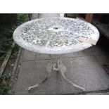 A Victorian style cream painted cast aluminium garden terrace table of circular form with decorative
