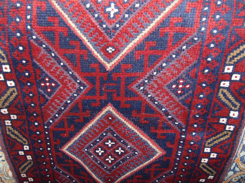 A Meshwari runner principally in a red and blue colourway, the five medallion centre within a