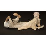 A Lladro Daisa of a reclining clown, number 4618, 36cm long approx (boxed)