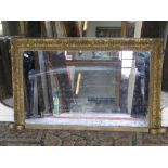 A small Victorian gilt framed chimney glass of rectangular form with moulded and foliate detail,