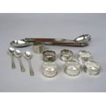 A mixed collection of silver to include seven silver napkin rings, three silver tea spoons, 5.5oz