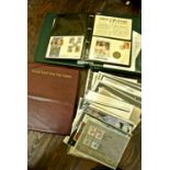 An album containing a collection of Coins and Stamps of the world, a further album containing FDC's,