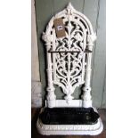A Victorian cast iron umbrella stand, the raised arched back with decorative pierced scrolling