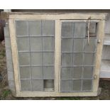 A reclaimed antique oak framed window enclosing two leaded light panels (one opening), together with