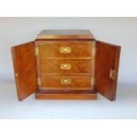 Early 20th century walnut and boxwood inlaid table top cabinet, the twin doors enclosing three small