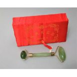 A boxed jade face massager, the box 18 cm long