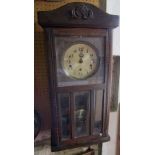 A vintage oak cased drop dial wall clock, with three train dial, 75cm high