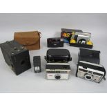 A box containing a collection of vintage Kodak cameras