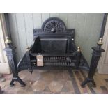 A 19th century cast iron fire basket in the Georgian style, the stepped arched back with foliate