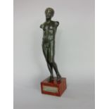 Grecian bronze study of a standing nude upon a red marble base, with white metal plaque inscribed "