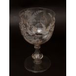 An antique oversized clear glass goblet, the bowl etched with a bird in flight amidst foliage, 29 cm