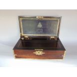 A good quality rosewood and brass inlaid writing slope, the hinged lid enclosing a gilt tooled