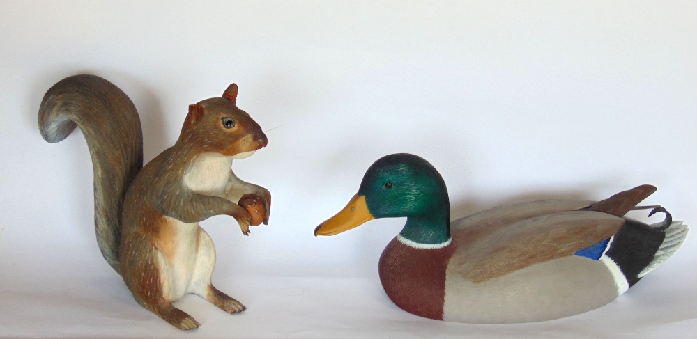 Two carved treen figures of animals to include a mallard and a squirrel, the mallard 34cm long (2)
