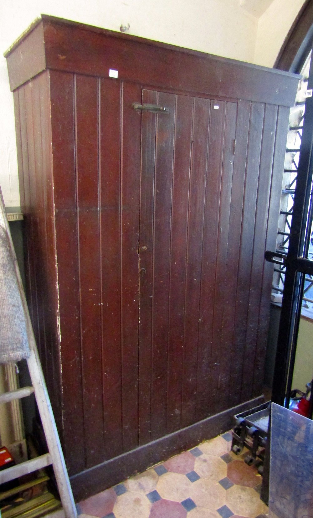 A vintage rustic stained pine side cupboard of tongue and groove boarded construction, floorstanding