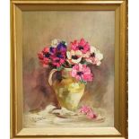 A 20th century still life on board with jug of anemones, possibly a print with oil textured