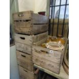 Six vintage wooden stacking crates with pierced handles and printed detail, two containing