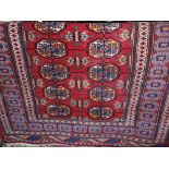 Bokhara type floor rug with typical medallion decoration upon a red ground, 180 x 130cm