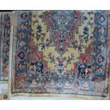 A pair of Persian style wool rugs with blue and pink ground central medallions upon pale cream