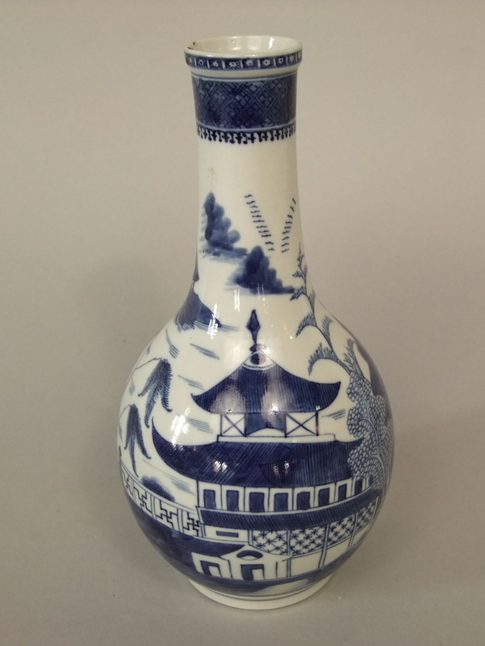 An oriental blue and white vase with pagoda detail, 26cm tall approx