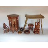 A collection of eastern treen items to include a carving of a Buddha, a carving of a fisherman, four