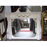 A large Georgian style overmantle mirror of rectangular form with shaped bevelled edge plate