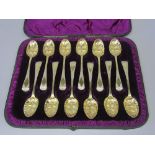 A Victorian cased suite of twelve silver gilt berry spoons, with bright cut handles, maker Charles
