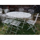 A steel framed garden table of oval form with lattice top raised on folding x framed supports,