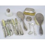 A mixed collection of silver to include three various silver dressing brushes, a silver lidded cut