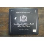 A 1977 Queens Silver Jubilee first day cover album produced by the Postal Heritage Society