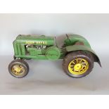 A scale model tin plate John Deere tractor with original cardboard box, 40cm long