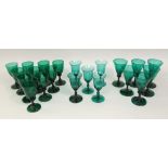 A collection of antique and later green glass goblets and wine glasses