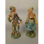 A pair of 19th century continental figures of male and female characters in Italian style costume,