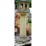 A weathered contemporary plaster composition stone bird table of octagonal form with simulated tiled