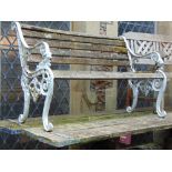 A cast iron garden bench with lion mask and scrolled supports and teak wood lathes