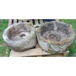 A pair of unusual circular stone troughs, 60cm diameter